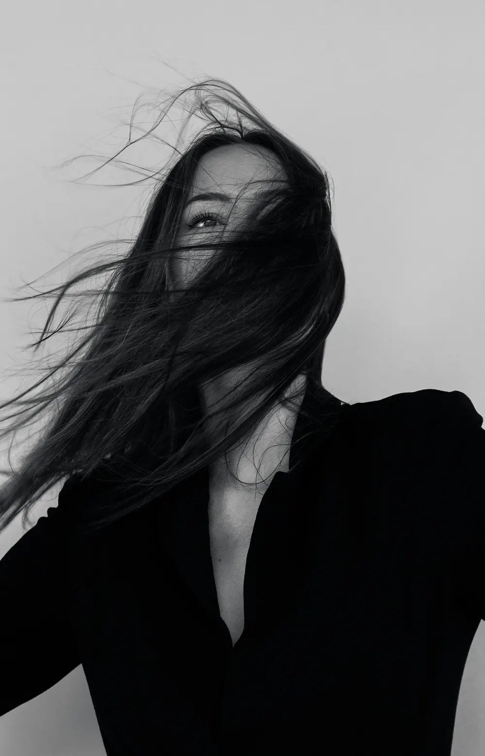 Editorial fashion portrait under directional studio light, styled for a brand campaign
